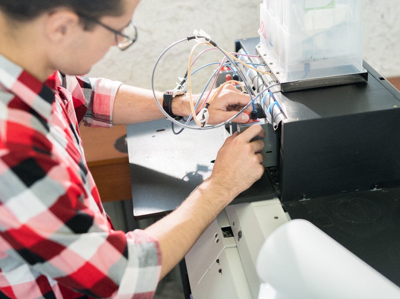 Printer repair technician working on a laser printer
