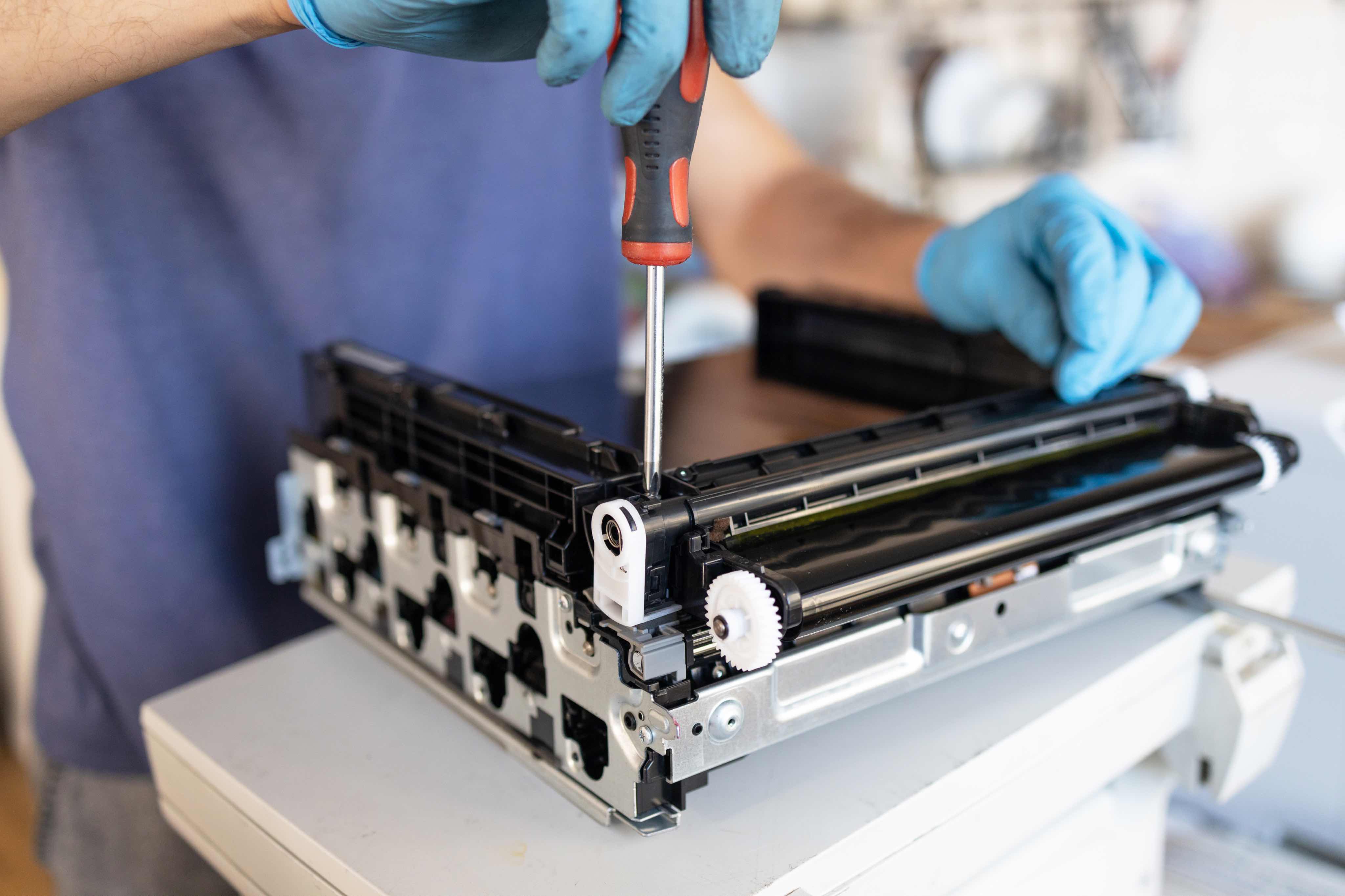Technician repairing a commercial laser printer